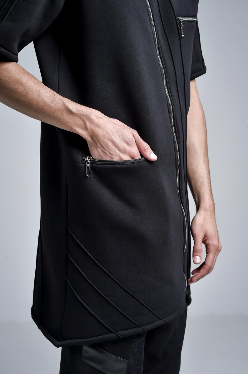 Puede incluir: Top negro estilo t&uacute;nica con cierre de cremallera y bolsillo con cremallera. El top tiene mangas cortas y detalles de costura decorativos. El modelo lleva el top. El top est&aacute; hecho de un material suave y c&oacute;modo.