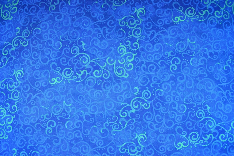 May include: A vibrant blue fabric with a repeating pattern of swirling, scroll-like designs in varying shades of blue and teal. The fabric has a textured appearance, suggesting a woven material.