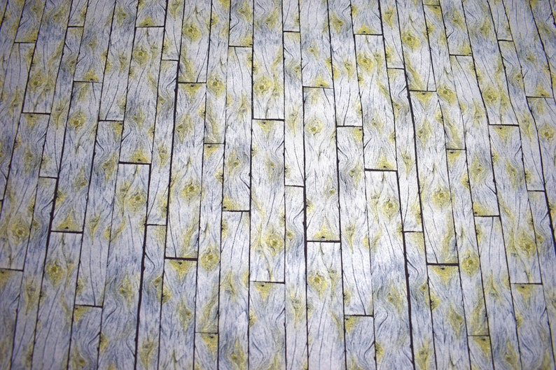 May include: A repeating pattern of vertical wooden planks. The planks are primarily white with gray and yellow accents, creating a rustic, weathered appearance. The design mimics the look of aged wood flooring.