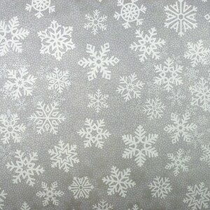 May include: A gray background with a repeating pattern of white snowflakes. The snowflakes are of various sizes and shapes.