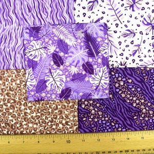 May include: A collection of fabric swatches featuring various patterns. Designs include purple zebra stripes, leopard spots, and tropical leaves in shades of purple and white. A ruler is at the bottom, showing measurements in inches.