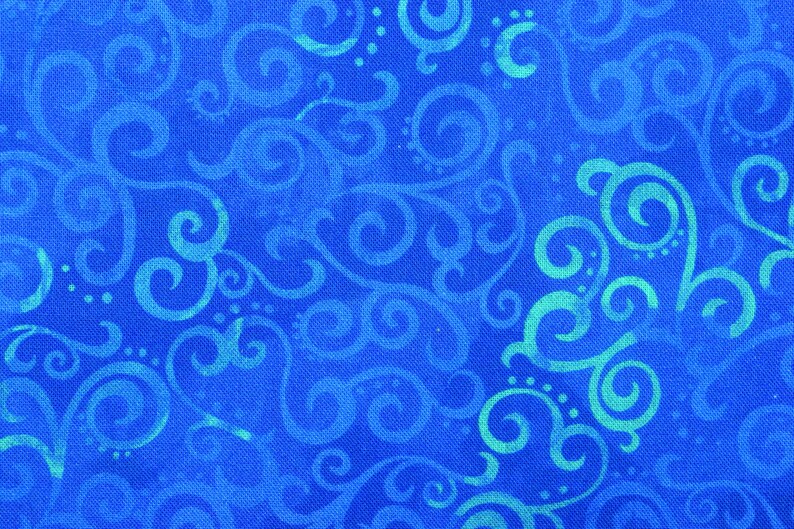 May include: Close-up of a blue fabric with a repeating pattern of swirling, scroll-like designs in a lighter shade of blue. The fabric has a textured appearance, with the lighter blue designs appearing to be painted on top of the darker blue background.