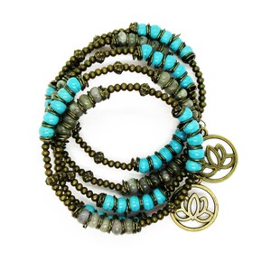 May include: A multi-strand bracelet featuring turquoise and grey beads, with two bronze lotus flower charms.