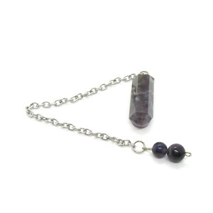 May include: A silver chain pendulum with a purple amethyst crystal point and two purple amethyst beads.