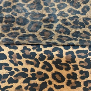 May include: Two pieces of fabric with a leopard print pattern. The top piece is a sheer mesh fabric with a brown background and black spots. The bottom piece is a solid fabric with a brown background and black spots.