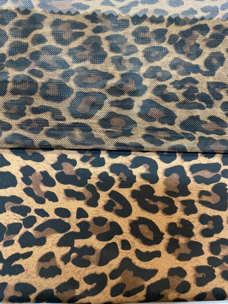 May include: Two pieces of fabric with a leopard print pattern. The top piece is a sheer mesh fabric with a brown background and black spots. The bottom piece is a solid fabric with a brown background and black spots.