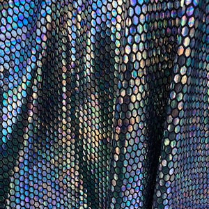 New hexagon hologram sequins on metallic spandex base 4way stretch 58/60” Sold by the YD. Ships worldwide from Los Angeles California USA.
