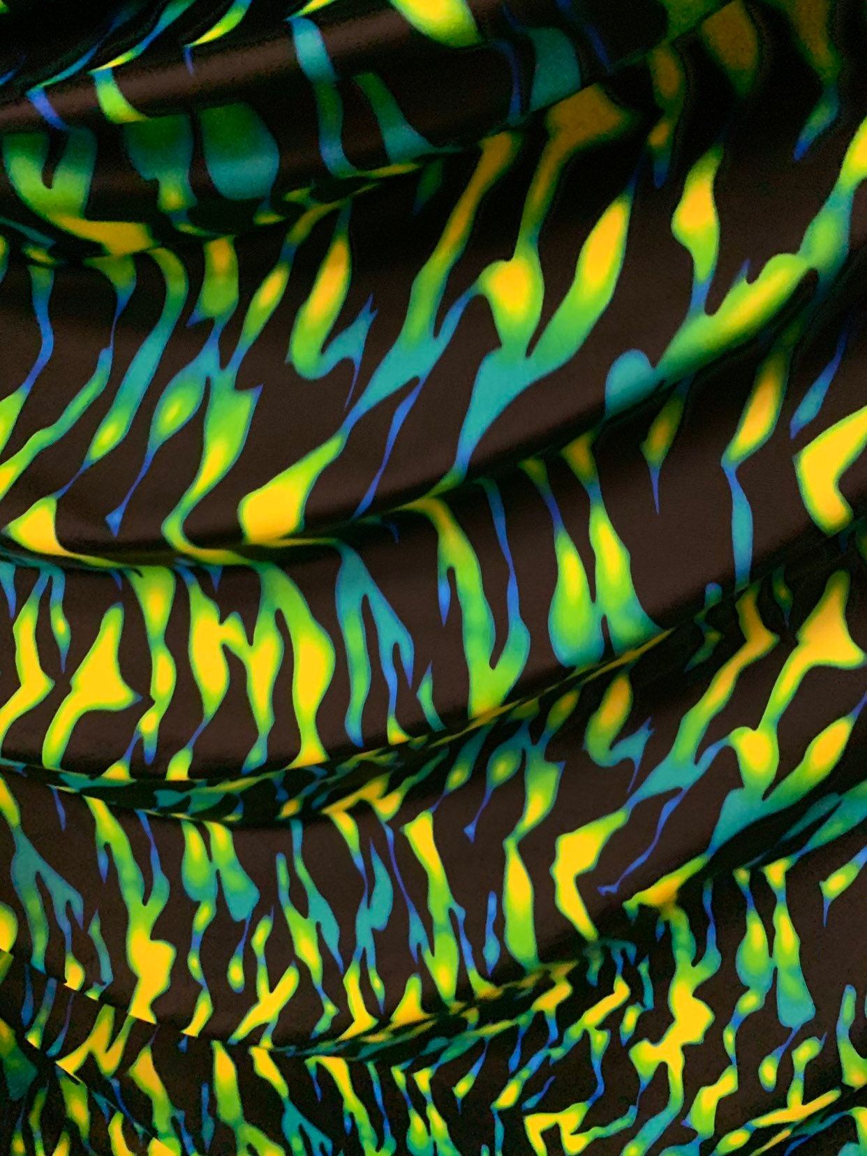 New tiger camouflage design black/green/yellow print on heavy nylon spandex 4way stretch 58/60" Sold by the YD. Ships worldwide from L.A CA.