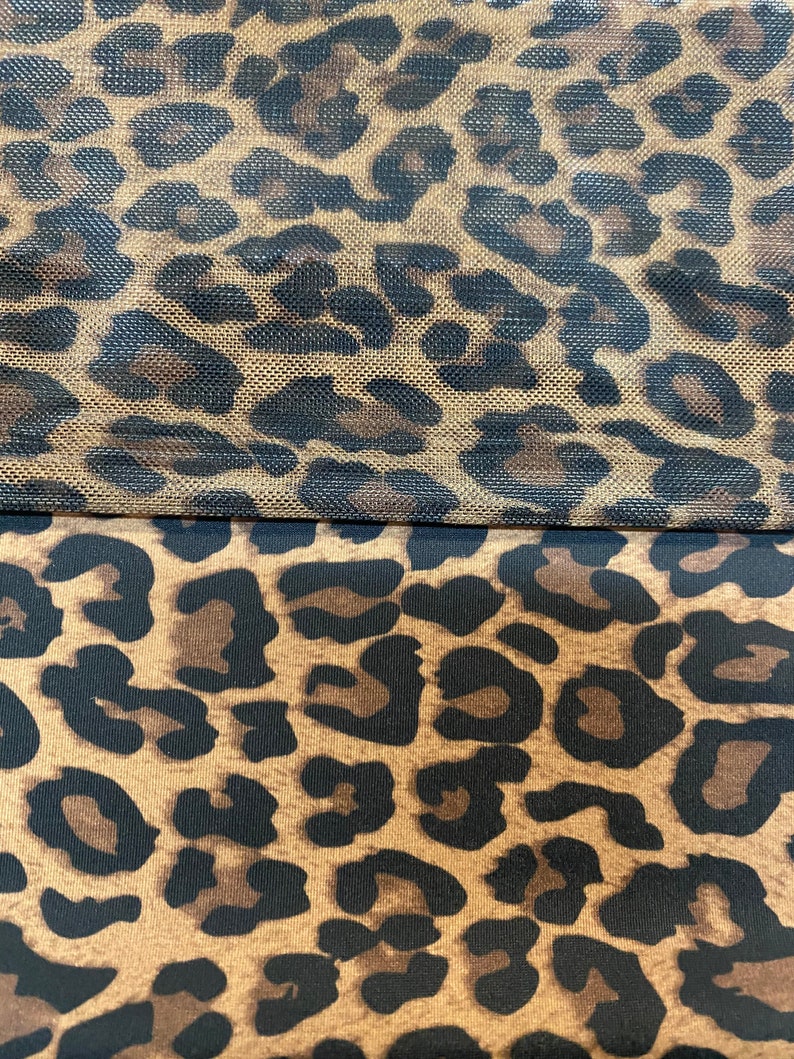 May include: Two pieces of fabric with a leopard print pattern. The top piece is a sheer mesh fabric with a brown background and black spots. The bottom piece is a solid fabric with a brown background and black spots.