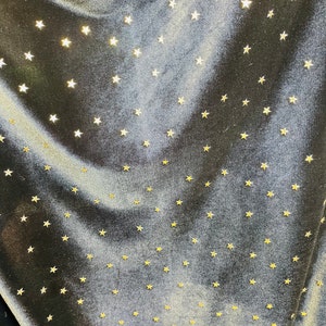 New stretch velvet with stars design black/Gold  4-way strech  58/60&quot; Sold by the YD. Ships worldwide from Los Angeles California USA.