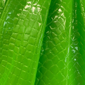 New crocodile stretch vinyl neon green & neon pink latex 4-way stretch 58/60” Sold by the YD. Ships worldwide from Los Ángeles California US