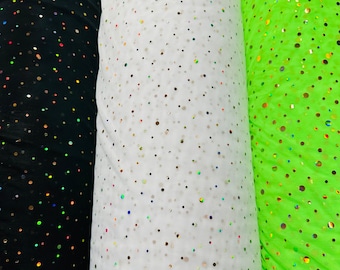 May include: Three rolls of iridescent mesh fabric with black, white, and lime green backgrounds. Each roll has small, colorful dots.