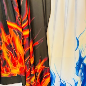 May include: Two fabric swatches with flame designs. One swatch is black with orange and yellow flames. The other swatch is white with blue flames.