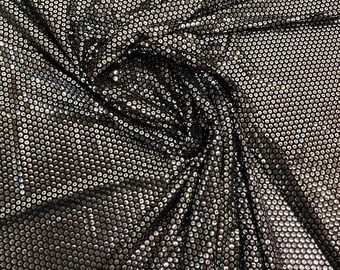 May include: Black fabric with silver sequins in a circular pattern.