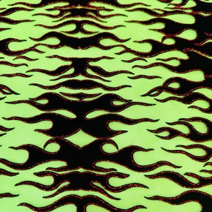 May include: Black and red flame pattern on a green background. The flames are outlined in red and have a glittery texture.