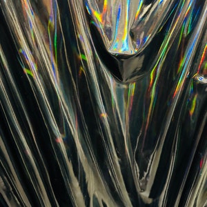 New lacer iridescent black vinyl 4-way stretch 58/60” Sold by the YD. Ships worldwide from Los Angeles California USA