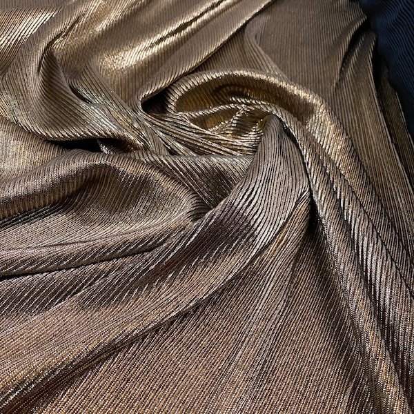 New accordion metallic pleated poly spandex black/gold 2-way Stretch 58/60” Sold by the YD. Ships Worldwide from Los Angeles California USA.