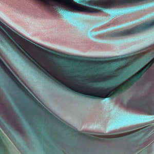 Metallic nylon spandex with foggy foil Navy/Teal iridescent foil 4-way stretch 58/60” Sold by the YD. Ships worldwide