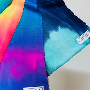 May include: Four fabric swatches with tie-dye patterns in different colors. The swatches are labeled "HOT PINK/BLUE" and "NAVY/GREEN".