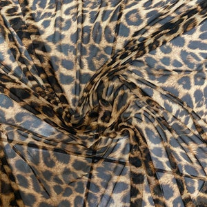 New exotic leopard design print on power mesh 4-way stretch 58/60” Sold by the YD. Ships worldwide from Los Angeles California USA.
