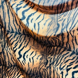 Tiger design Exotic animal print on great quality of nylon spandex 4-way stretch 58/60” Sold by the YD. Ships Worldwide from Los Ángeles CA