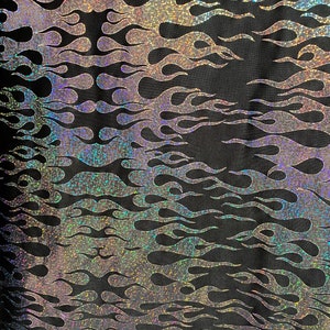 New hologram flames design metallic poly spandex black/silver 2-way stretch 58/60” Sold by the YD. Ships worldwide from Los Angeles CA USA.