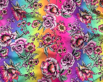 May include: A colorful fabric with a rainbow gradient background and a floral pattern. The flowers are pink, white, and green, and they are arranged in a repeating pattern.