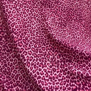 May include: Pink fabric with a leopard print pattern.