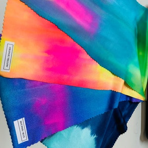 May include: Five fabric swatches in different tie-dye patterns. The swatches are labeled "Navy Green", "Hot Pink Blue", "Orange/Yellow", and "Multi Pastel".