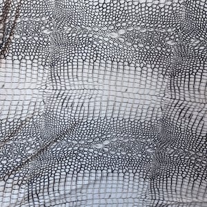 May include: White faux leather with a black crocodile pattern.