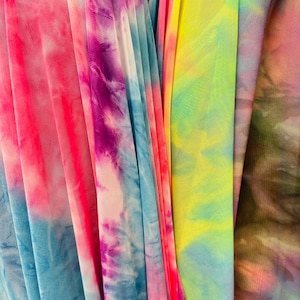 Tie dye design power mesh 4-way stretch 58/60” Sold by the YD. Ships Worldwide from Los Angeles California USA.