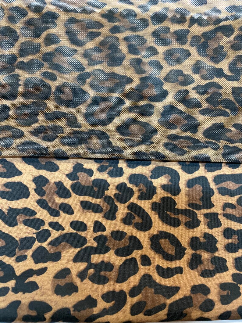 May include: Two pieces of fabric with a leopard print pattern. The top piece is a sheer mesh fabric with a brown and black leopard print. The bottom piece is a solid fabric with a brown and black leopard print.