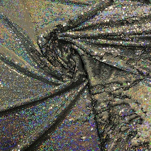 New hologram silver/silver reversible flip up sequins on spandex base 2-way stretch 58/60” Sold by the YD. Ships worldwide from Los Angeles