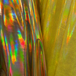 New Iridescent foggy foil oil effect metallic nylon spandex and iridescent metallic vinyl 4way stretch Sold by the YD. Ships worldwide