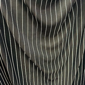 Pin stripes on nylon spandex 4-way stretch 58/60” Sold by the YD. Ships worldwide from Los Angeles California USA.