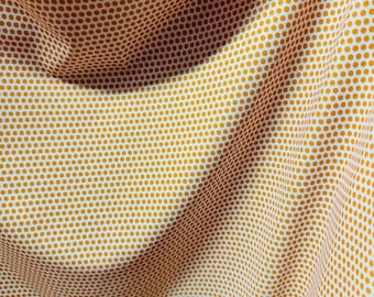 May include: White fabric with a repeating pattern of small, golden brown polka dots. The fabric is draped and folded, creating a textured look.