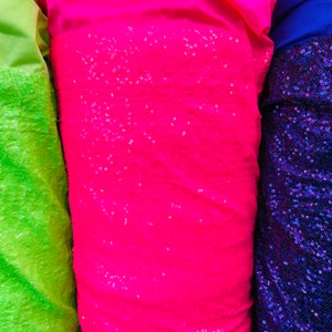 New shining glitz sequins Cosmic glow design sewn onto solid spandex 4way stretch 58/60” Sold by the YD. Ships worldwide from Los Angeles CA