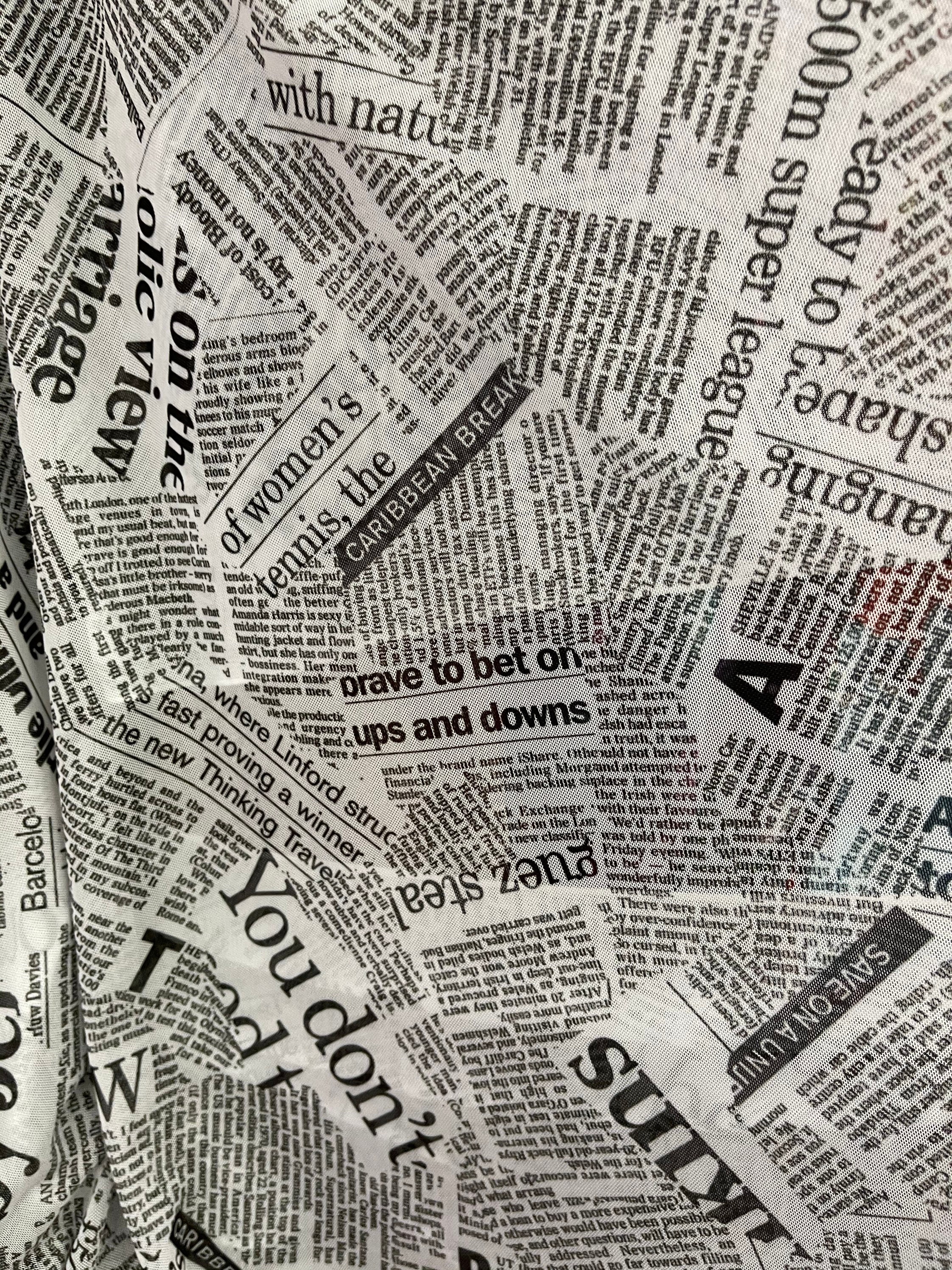 Ameri（アメリ）の「UND SPACE NEWSPAPER PRINT TOP（Tシャツ
