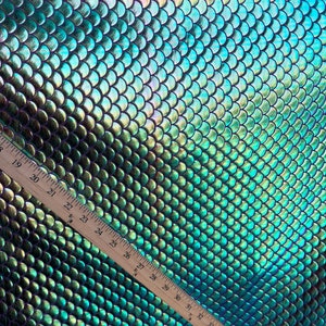 New mermaid design iridescent purple green fish scales foil 4way Stretch 58/60" Sold by the YD. Ships Worldwide from Los Angeles California.