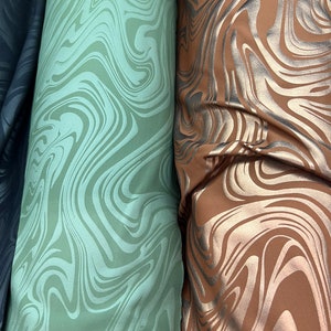 New Modern abstract design foiled nylon spandex 4 way stretch 58/60” Sold by the YD.