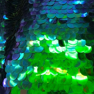 Iridescent mermaid green big paillette sequins on stretch mesh base 2way 58/60&quot;  Sold by the YD. Ships worldwide from Los Angeles California