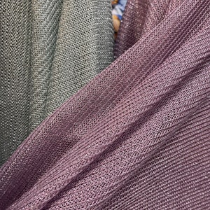May include: Two pieces of fabric, one is a light gray and the other is a dark purple. Both fabrics have a shiny, textured, woven pattern.