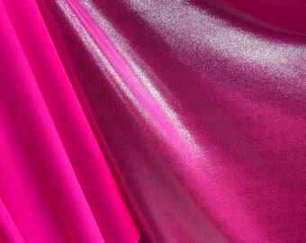 May include: Two pieces of fabric, one a shiny pink with a metallic sheen and the other a matte pink. The fabric is folded and draped.