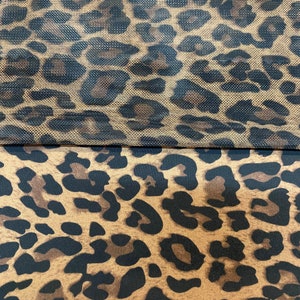 May include: Two pieces of fabric with a leopard print pattern. The top piece is a sheer mesh fabric and the bottom piece is a solid fabric.