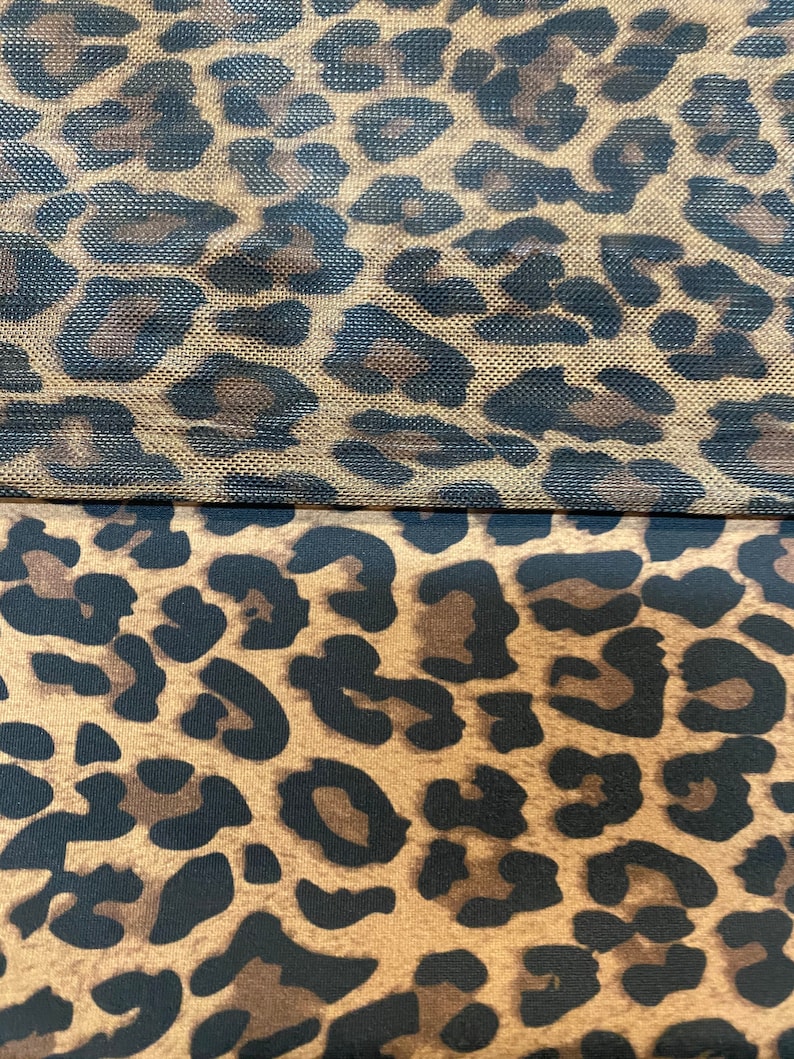 May include: Two pieces of fabric with a leopard print pattern. The top piece is a mesh fabric with a brown and black leopard print. The bottom piece is a solid fabric with a brown and black leopard print.
