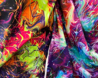 May include: Abstract fabric with a colorful, swirling, and splattered design. The fabric features a mix of bright colors, including pink, orange, yellow, green, blue, and purple.