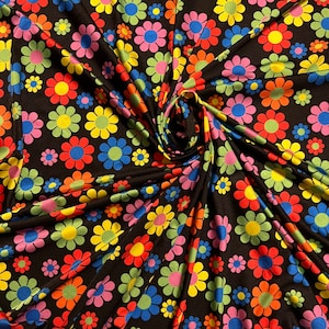 New daisy flower design Black/Multicolor print on great quality of nylon spandex 4-way stretch 58/60” Sold by the YD.