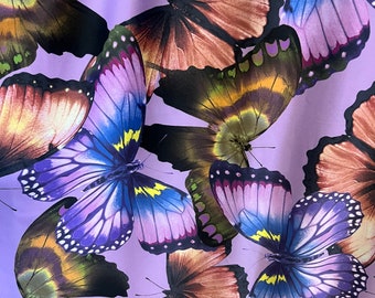 May include: A purple background with a repeating pattern of colorful butterflies. The butterflies have brown, purple, blue, and yellow wings.