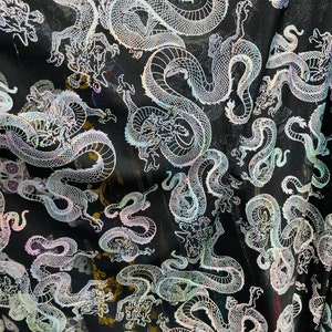 Exotic Dragon design print on metallic power mesh nylon spandex 4-way stretch 58/60” Sold by the YD. Ships worldwide from Los Ángeles CA USA