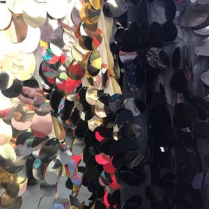 New Iridescent teardrops sequins jumbo size on stretch mesh 2way 58/60" Sold by the YD. Ships worldwide from Los Angeles CA, USA.